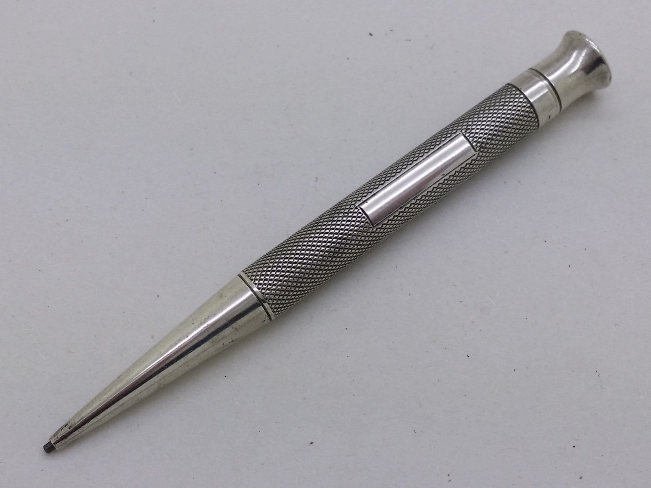 George V 1933 sterling silver "The Mascot" propelling pencil with engine turned shaft, Birmingham, by Edward Baker & Son