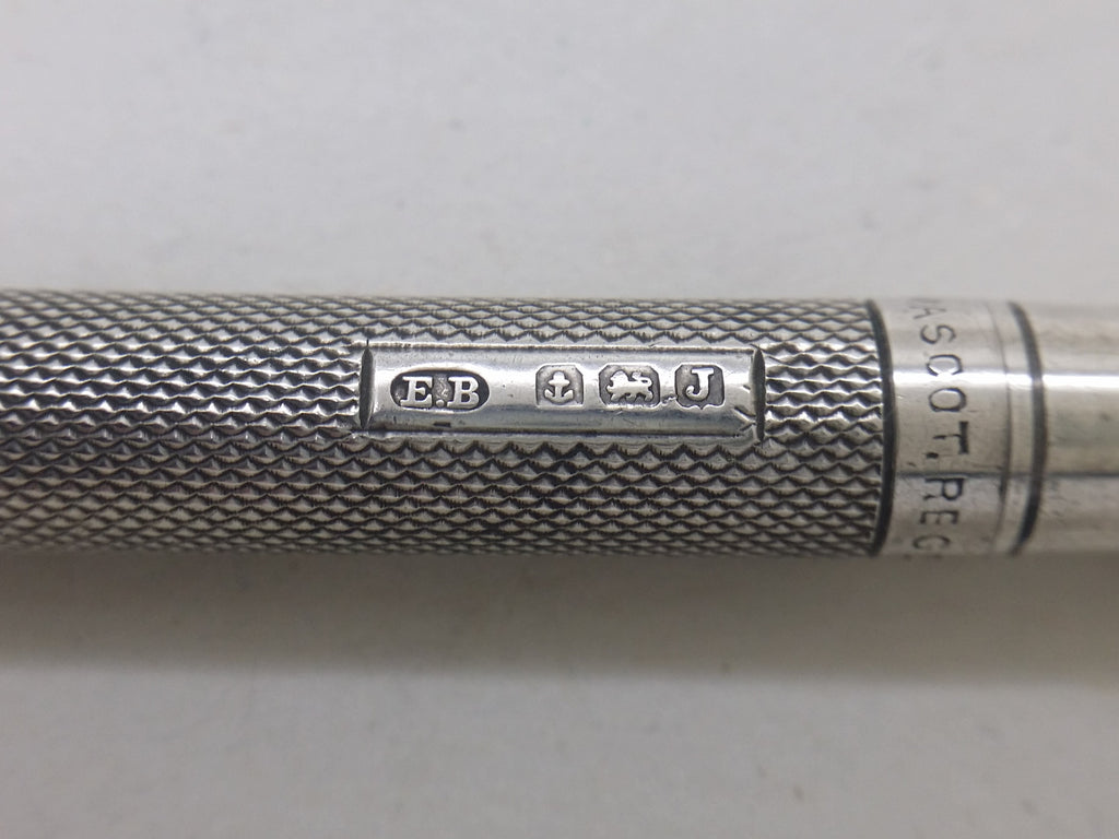 Propelling pencil hallmarks: Edward Baker & Son maker's mark EB; anchor mark for Birmingham; lion passant mark for sterling silver; and Birmingham date letter J for 1933.