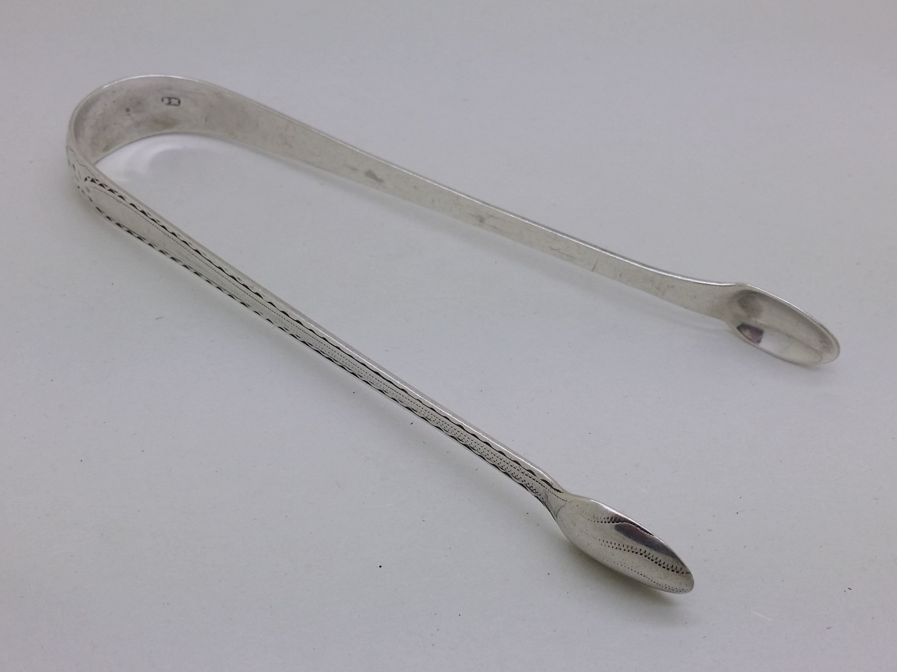 George III c.1785 sterling silver bright cut sugar tongs, London, by Benjamin Mountigue.
