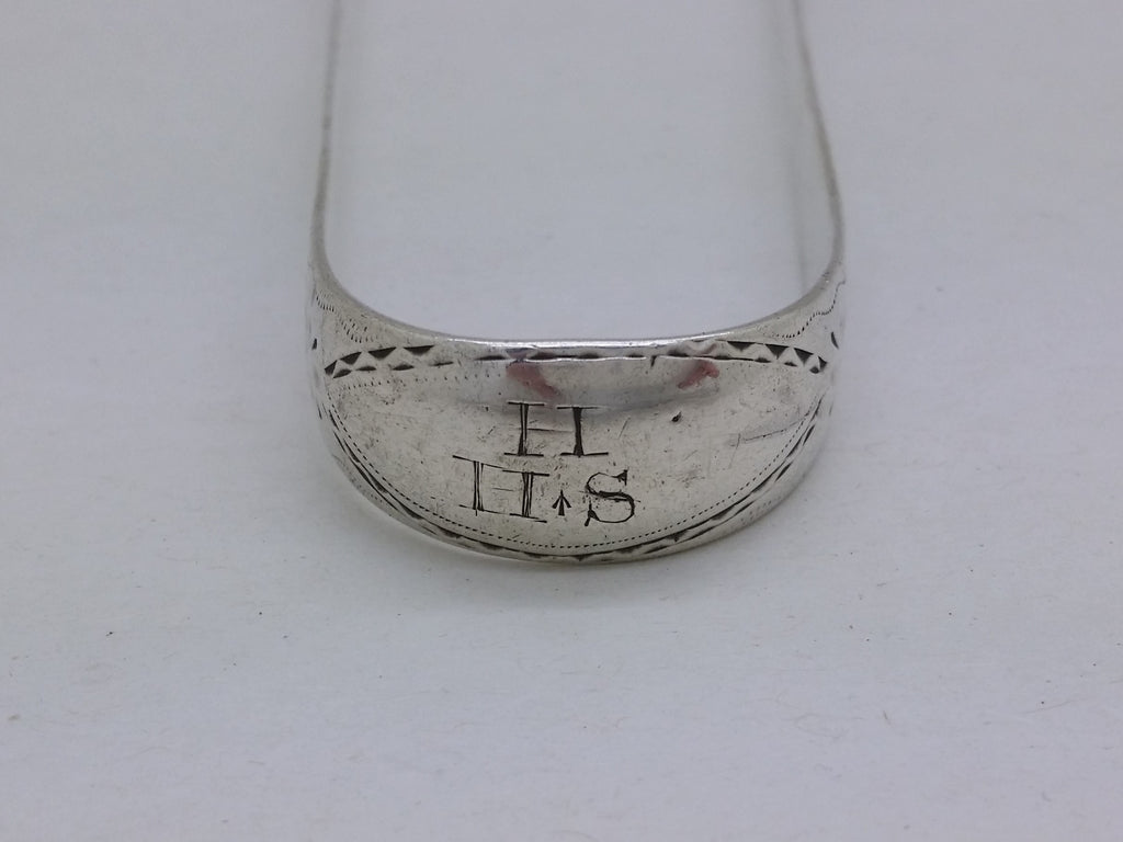 Bow of sterling silver sugar tongs with matrimonial initial inscription H over H S, with the first letter denoting the surname, and the two letters together denoting the Christian names of the wedded couple.