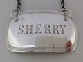 Close-up of the decanter label, showing the hand-cut letters SHERRY, and triple thread border.