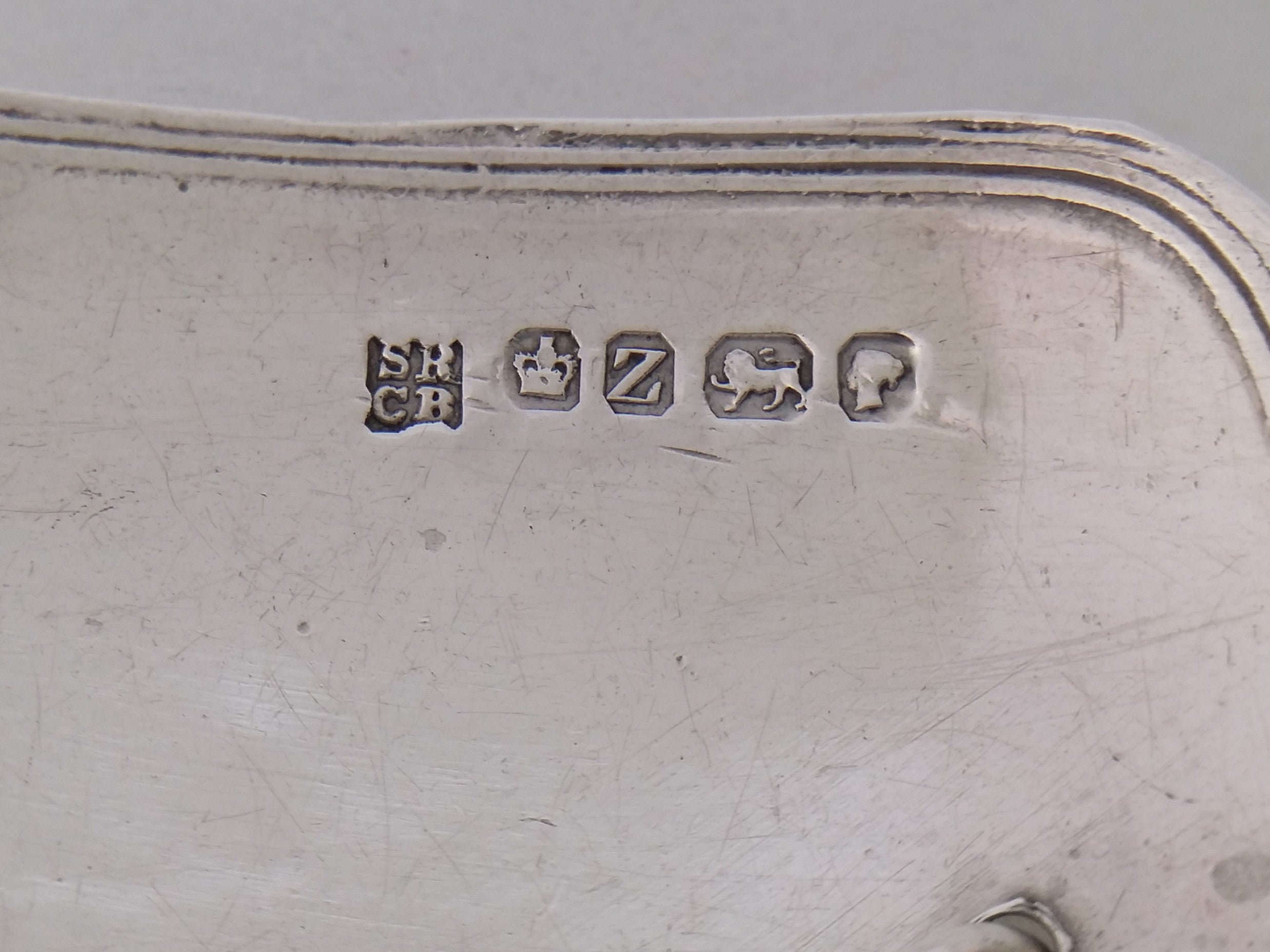 Sherry decanter label hallmarks: Samuel Roberts & Charles Belk makers mark SRCB; crown mark for Sheffield; Sheffield date letter Z for 1867; lion passant mark for sterling silver; and the Victoria duty mark.