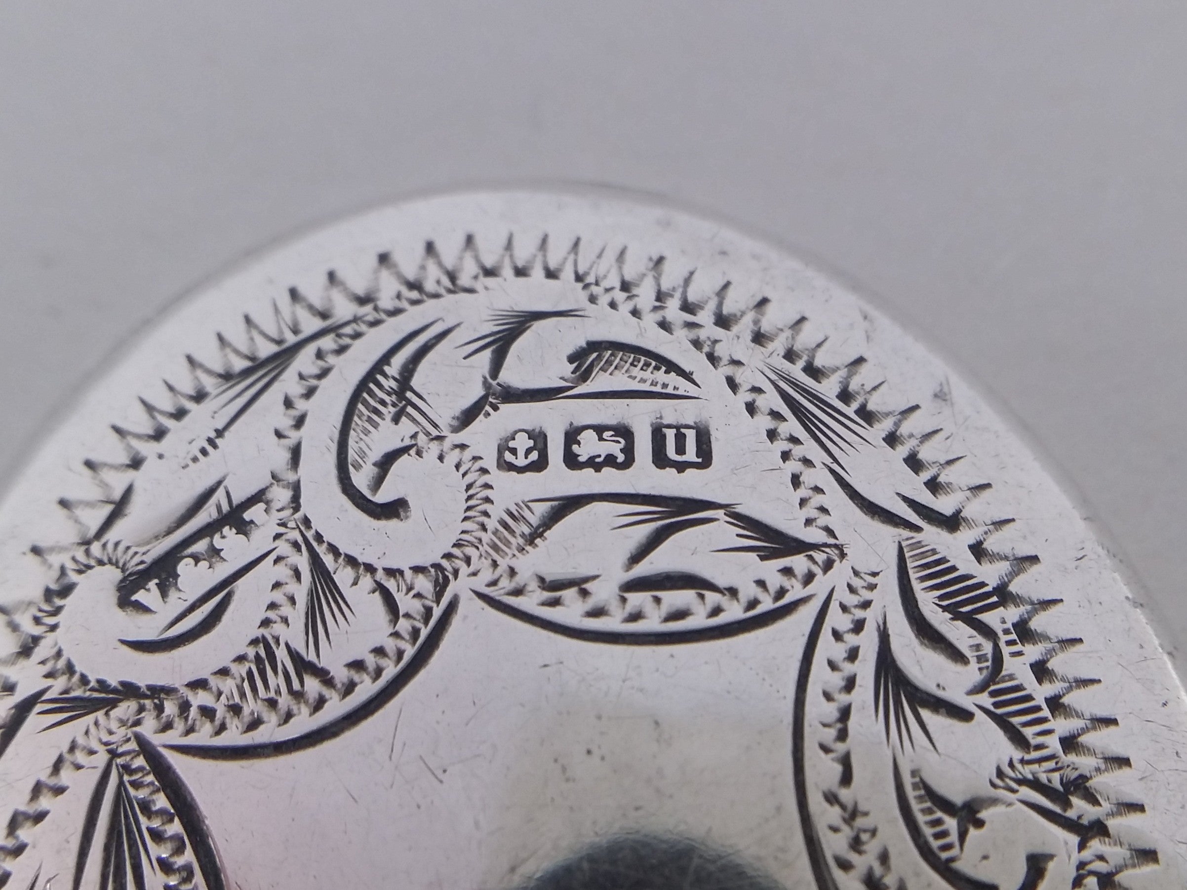 Miniature mirror hallmarks: anchor mark for Birmingham; lion passant mark for sterling silver; and Birmingham date letter u for 1919.