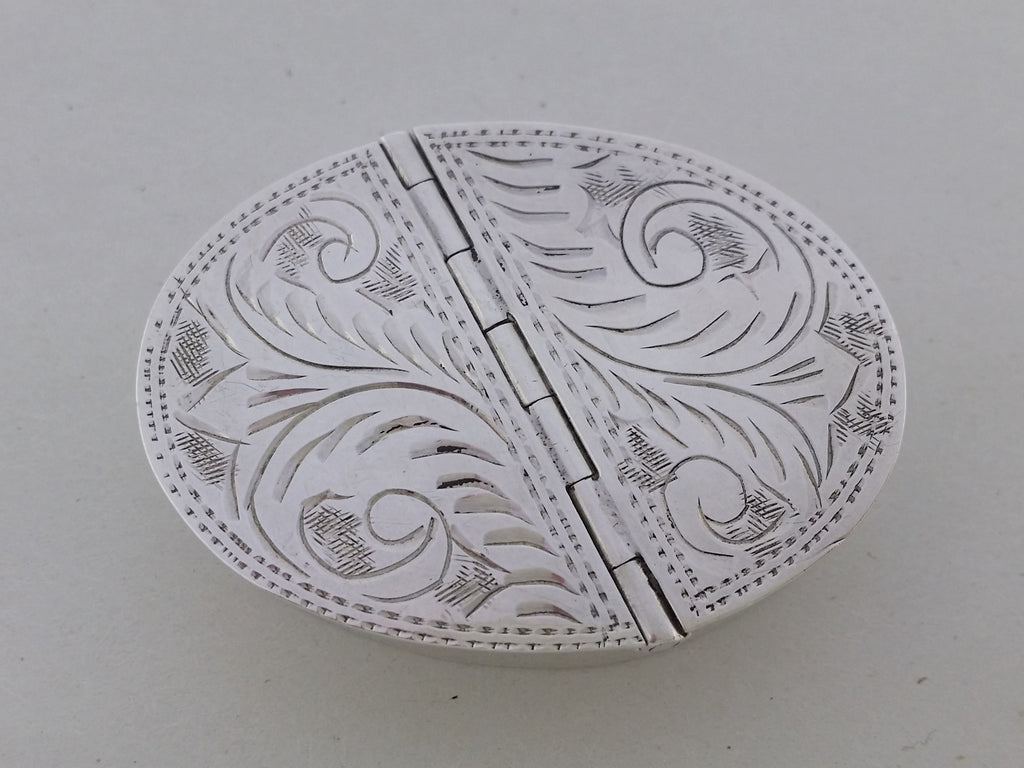 Pill box foliate engraved double hinged lids with stippled edging.