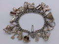 Elizabeth II 1969 sterling silver charm bracelet with 29 charms, Birmingham by Clarke Brothers (Liverpool) Ltd