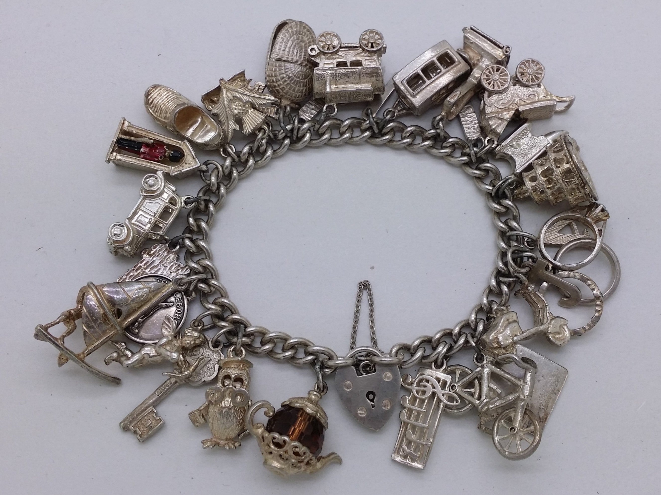 Elizabeth II 1969 sterling silver charm bracelet with 29 charms, Birmingham by Clarke Brothers (Liverpool) Ltd