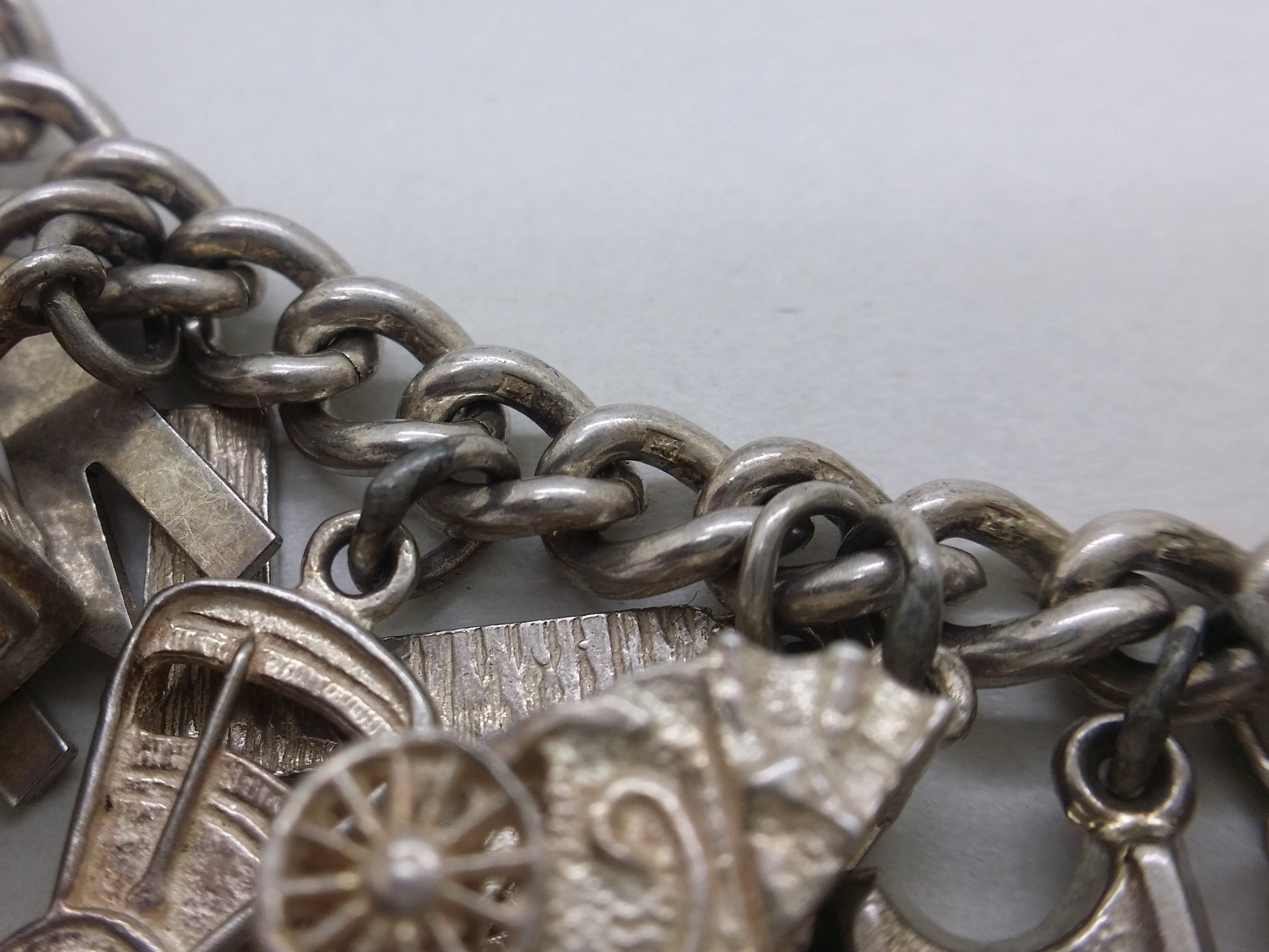 Lion passant marks on sterling silver charm bracelet links