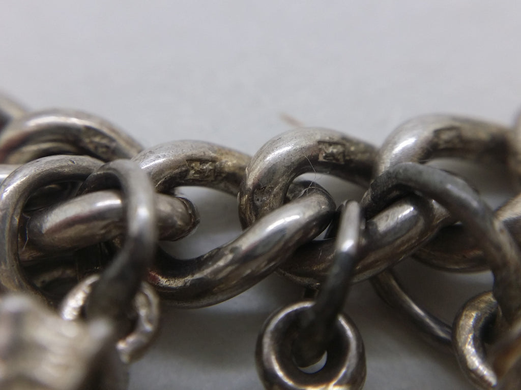 Lion passant marks on sterling silver charm bracelet links