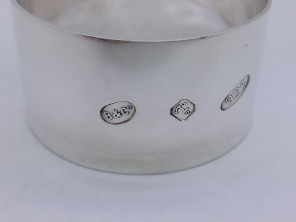 Napkin ring hallmarks: Broadway & Co maker's mark B&CO; anchor mark for Birmingham; and 925 mark for sterling silver.