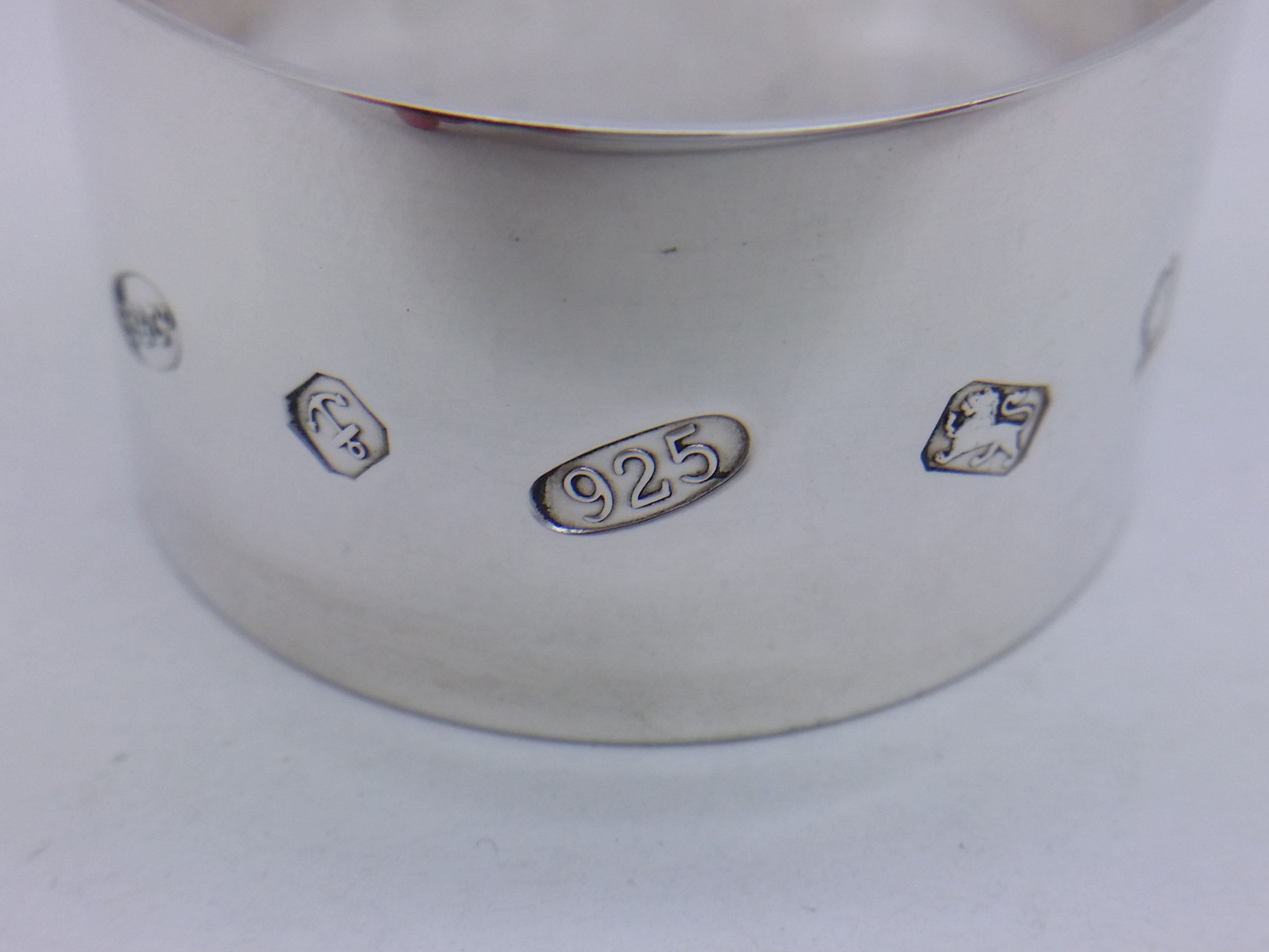 Napkin ring hallmarks: Broadway & Co maker's mark B&CO; anchor mark for Birmingham; 925 mark and lion passant mark for sterling silver; and the commemorative Elizabeth II golden jubilee mark.