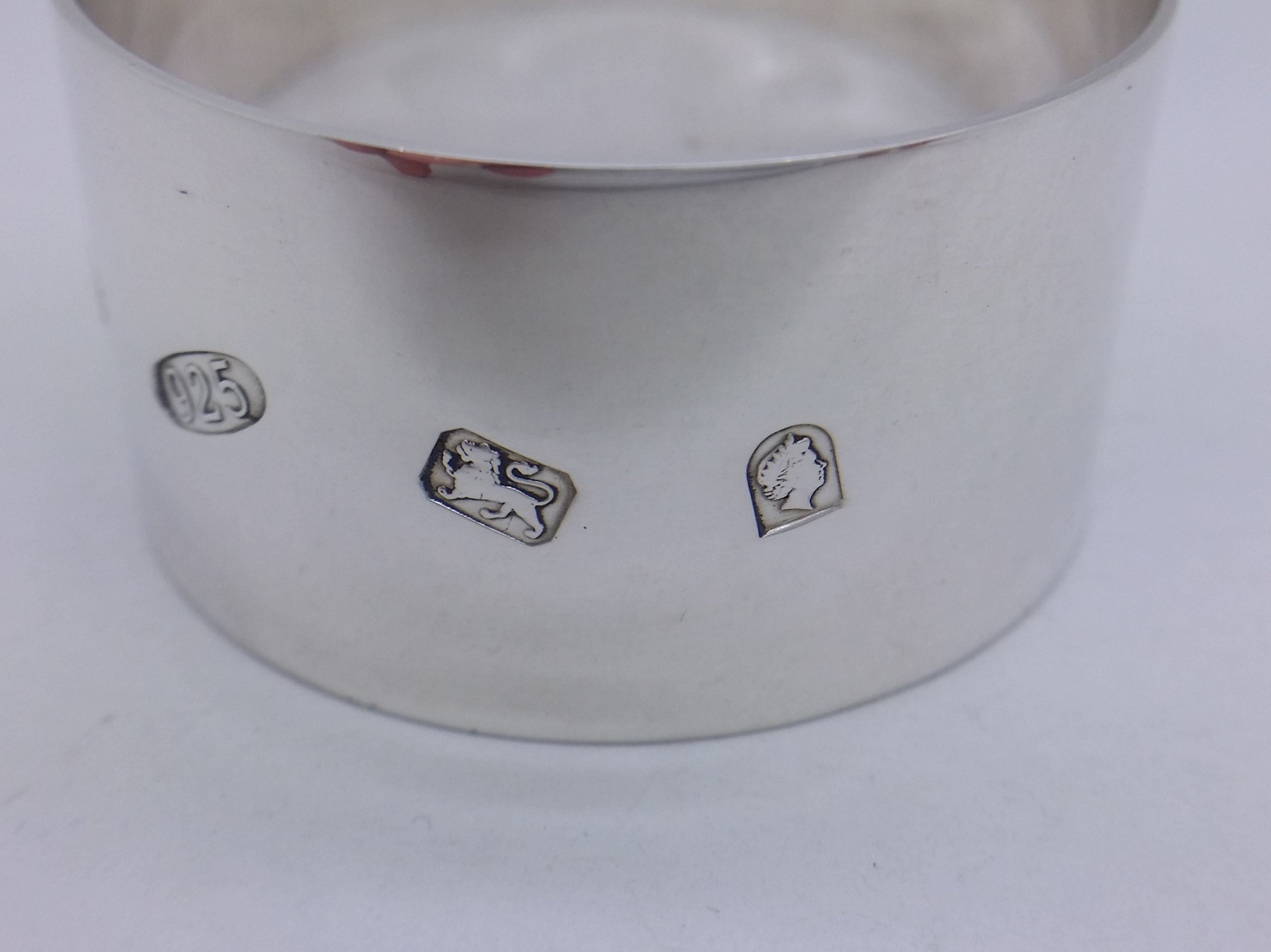 Napkin ring hallmarks: 925 mark and lion passant mark for sterling silver; and the commemorative Elizabeth II golden jubilee mark.