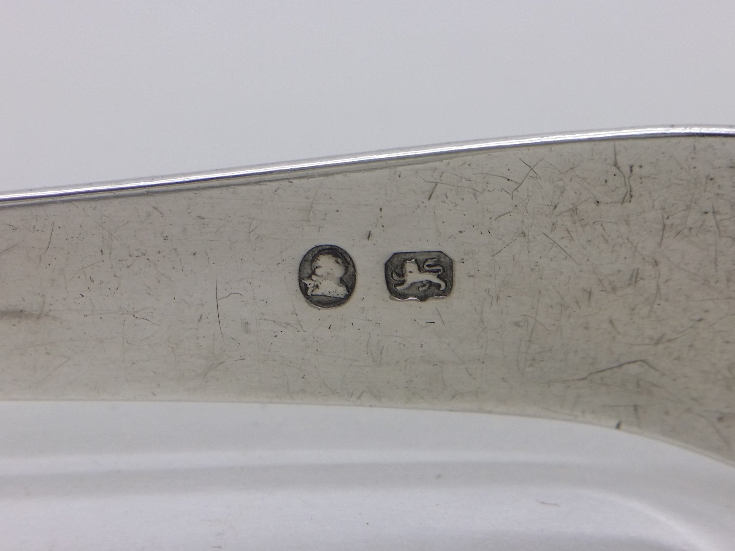Sugar tongs simplified hallmarks: George III duty mark; and lion passant mark for sterling silver.