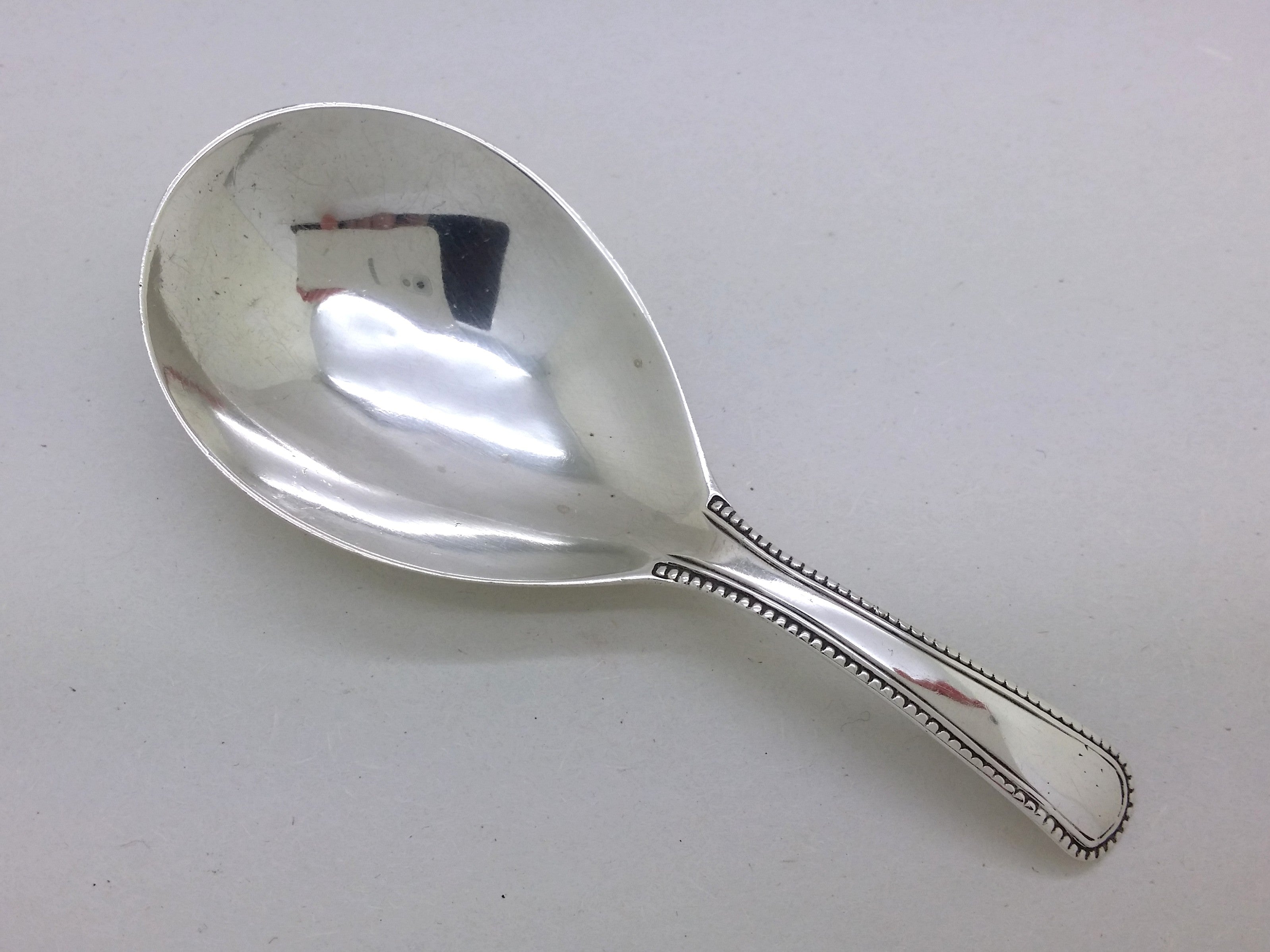 George III 1794 sterling silver beaded pattern caddy spoon, London by Thomas Wallis II