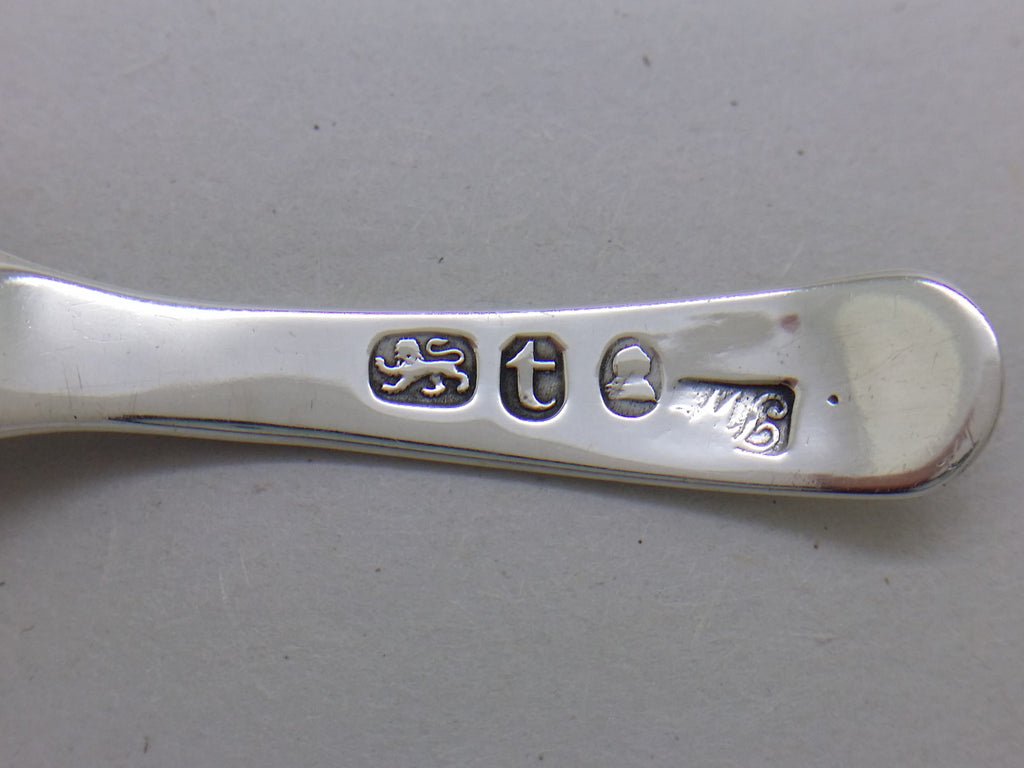 Caddy spoon hallmarks: lion passant mark for sterling silver; London date letter t for 1794; the George III duty mark; and Thomas Wallis II maker's mark TW (upside down).
