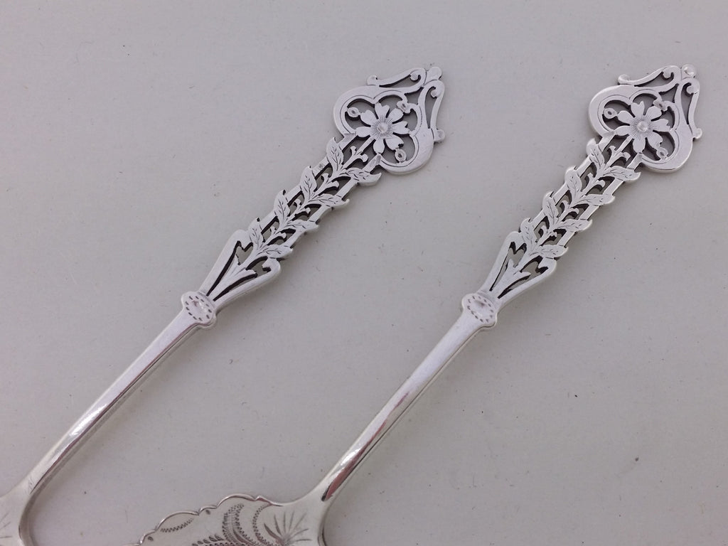 Sterling silver jam spoon handles of pierced floral sunflowers within an outer scrolled stem.