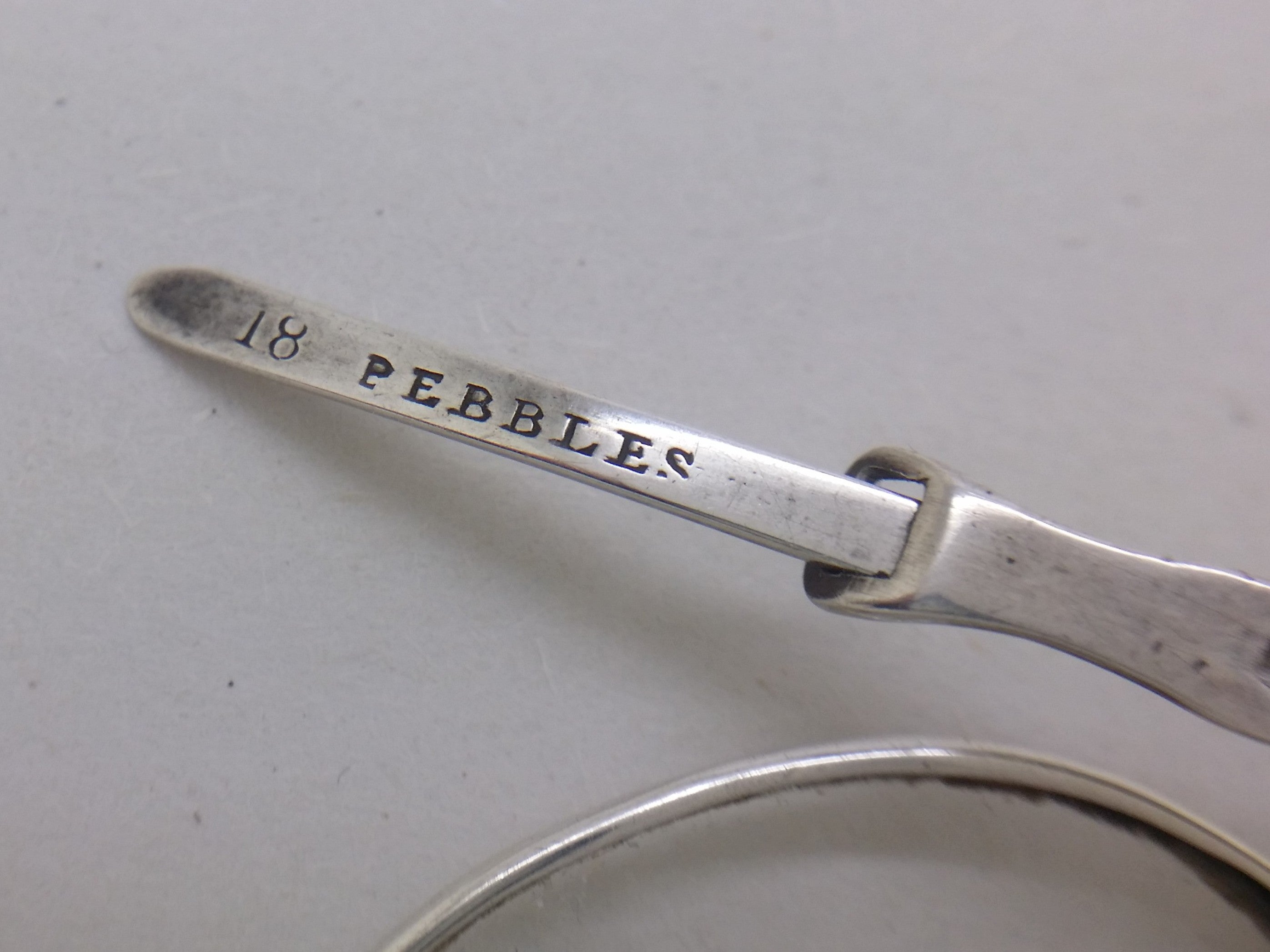 PEBBLES stamped on the arm of early Victorian spectacles, meaning they were fitted with scratch-resistant quartz crystal lenses