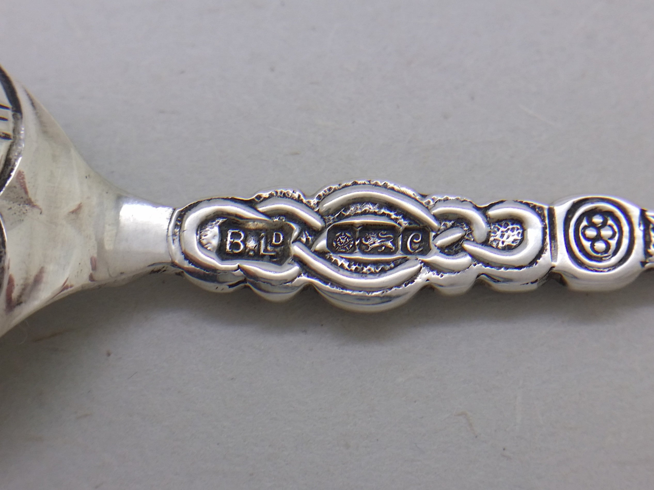 Anointing spoon hallmarks: Bishton's Ltd makers mark BLD; Tudor rose mark for Sheffield; lion passant mark for sterling silver; and UK date letter C for 1977.