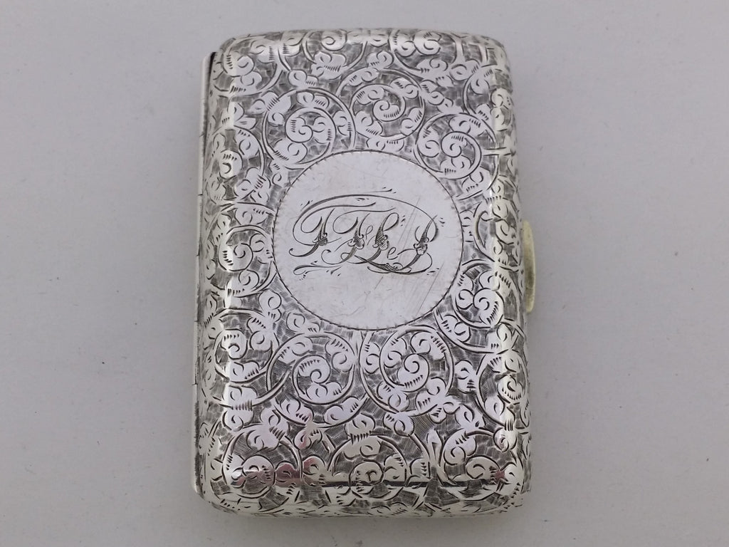 Sterling silver cigarette case with engraved acanthus scrolled decoration, and an inscribed circular cartouche TFLP