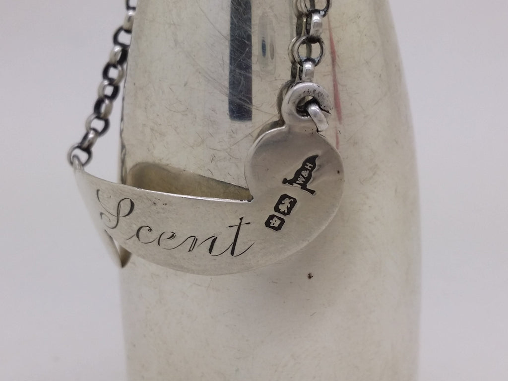 Scent bottle label hallmarks: crown mark for Sheffield; lion passant mark for sterling silver; and Walker & Hall maker's mark W&H.