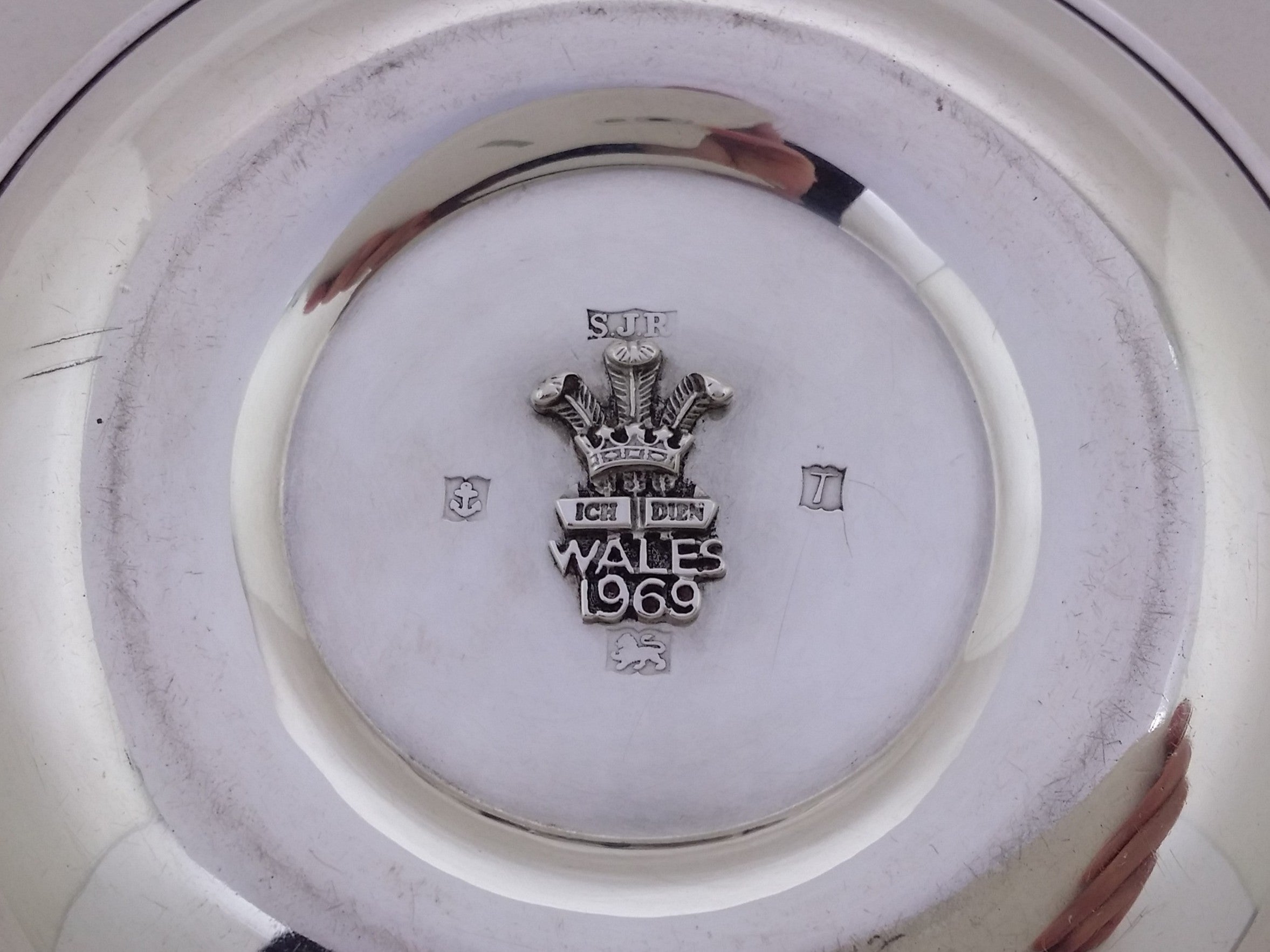 Dish hallmarks around the applied central Prince of Wales Fleur de Lys monogram: S J Rose & Son maker's mark SJR; anchor mark for Birmingham; Birmingham date letter T for 1968; and lion passant mark for sterling silver.