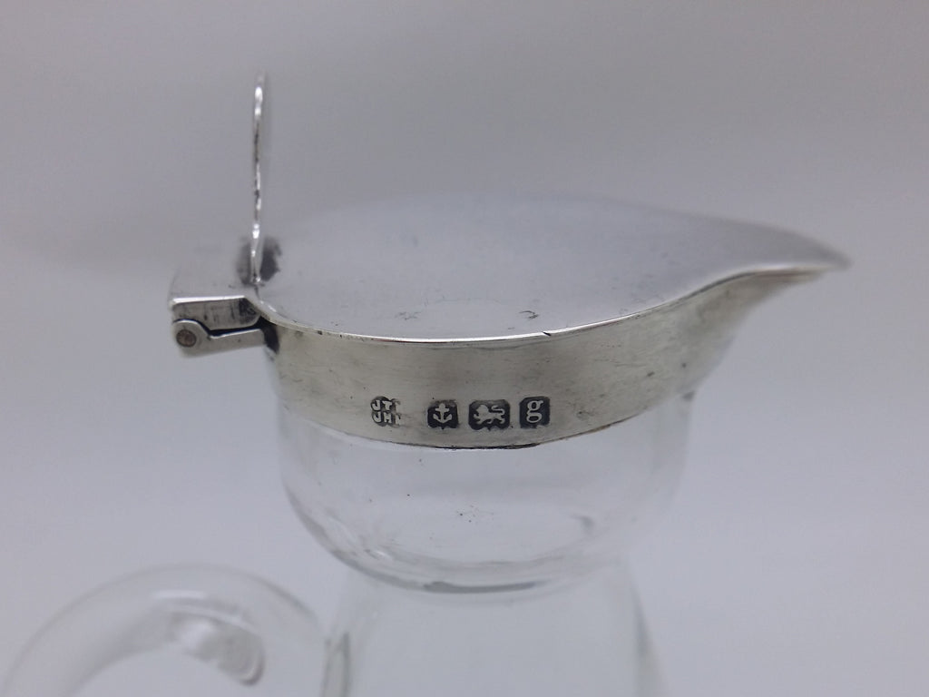 Decanter hallmarks: Hukin & Heath maker's mark JTHJHM for John Thomas Heath & John Hartshorne Middleton; anchor mark for Birmingham; lion passant mark for sterling silver; and Birmingham date letter g for 1906.