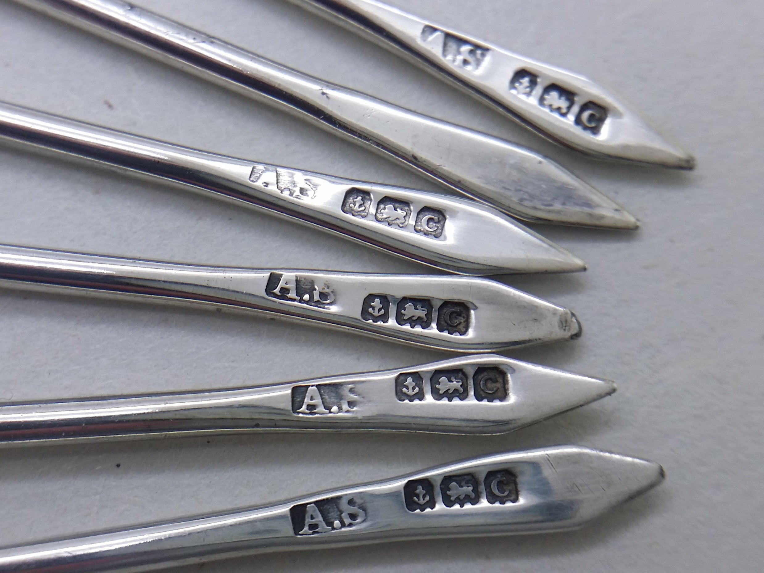 Cocktail stick hallmarks: Adolph Scott maker's mark AS; anchor mark for Birmingham; lion passant mark for sterling silver; Birmingham date letter C for 1927.