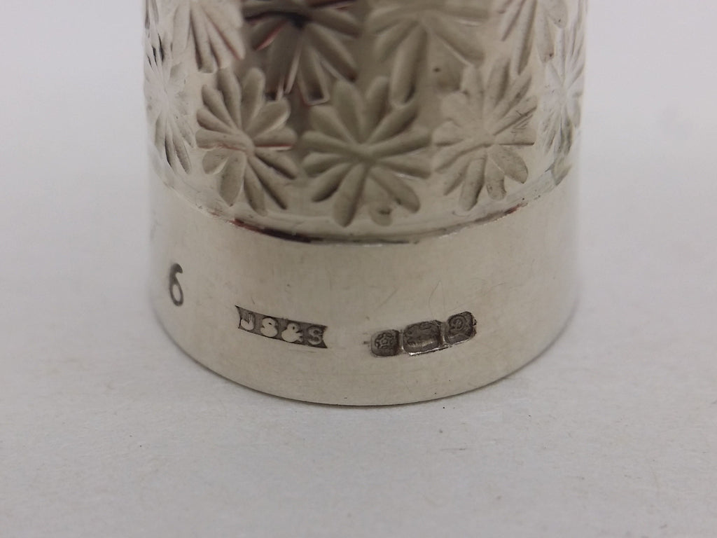 Thimble hallmarks: Size 6 mark; James Swann & Son maker's mark JS&S; Tudor rose mark for Sheffield; lion passant mark for sterling silver; and UK date letter D for 1978.
