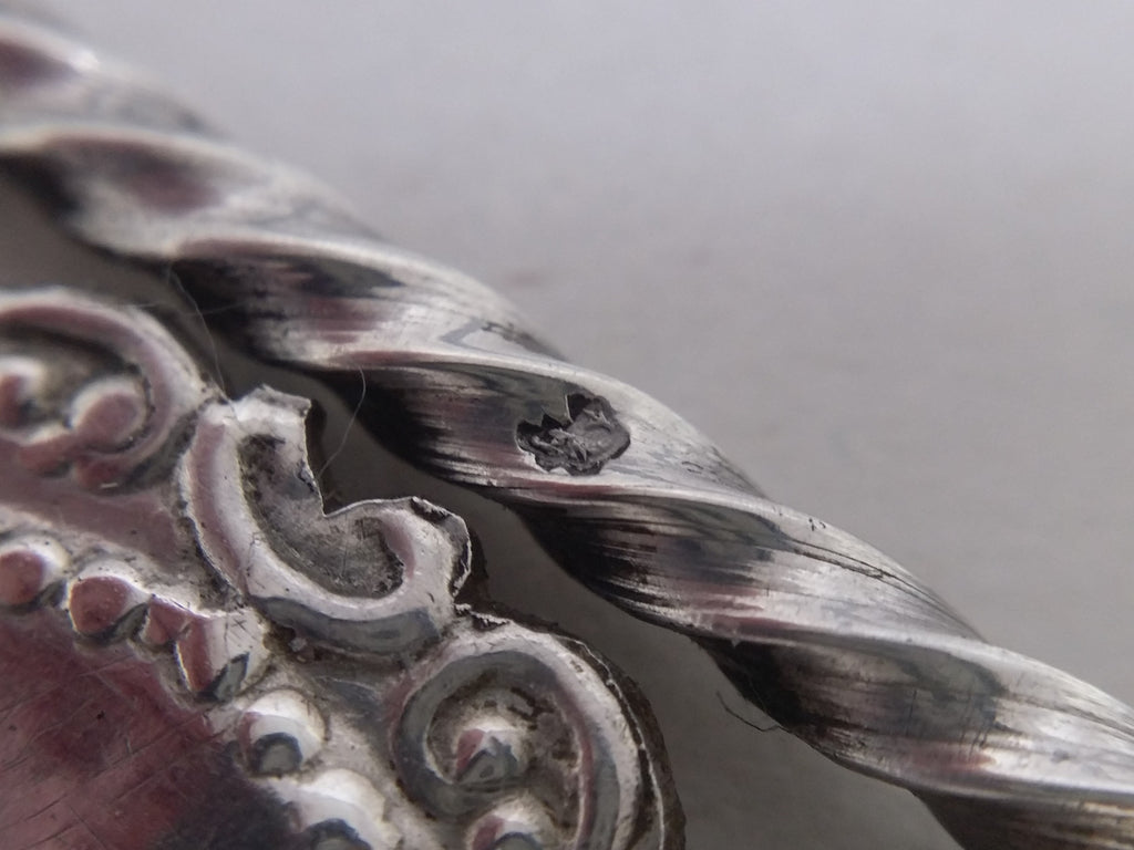 Miniature chair with Dutch fish duty mark within a contoured stamp, was used on domestic articles between 1859-1893, when the silver tolerences were not met.