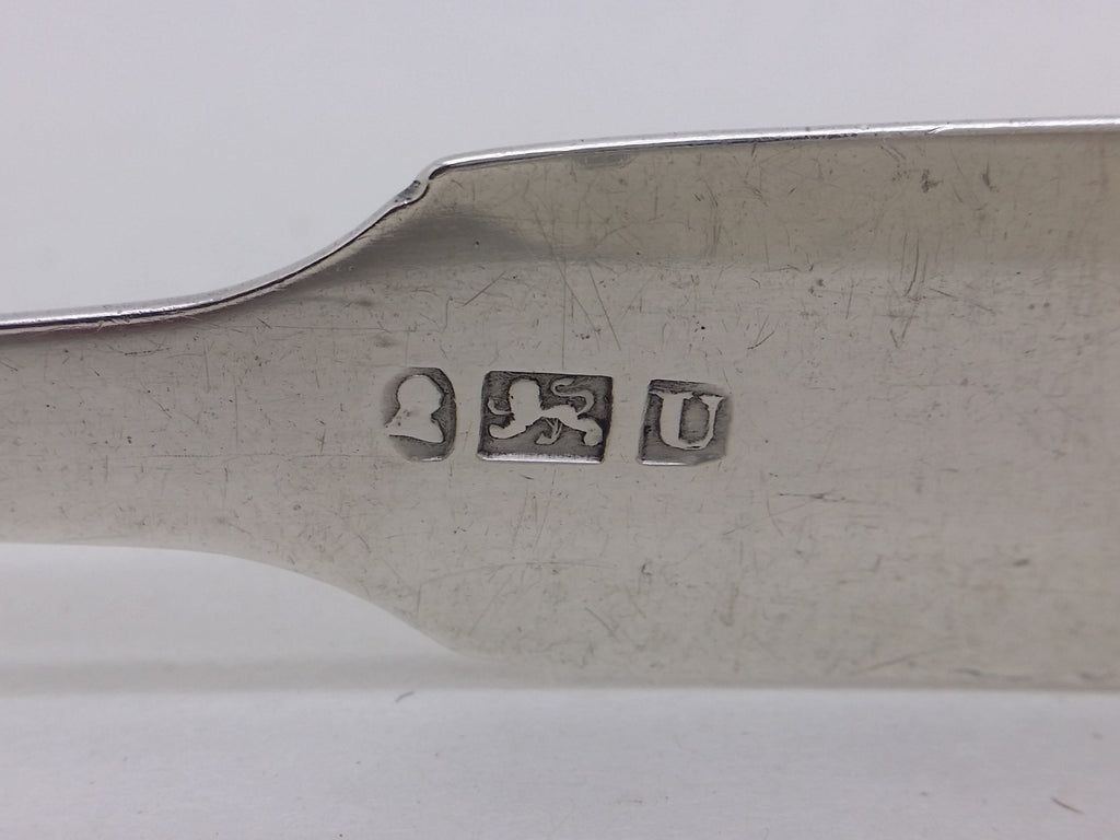 Sugar tongs hallmarks: George III duty mark; and lion passant mark for sterling silver; and Exeter date letter U for 1816.