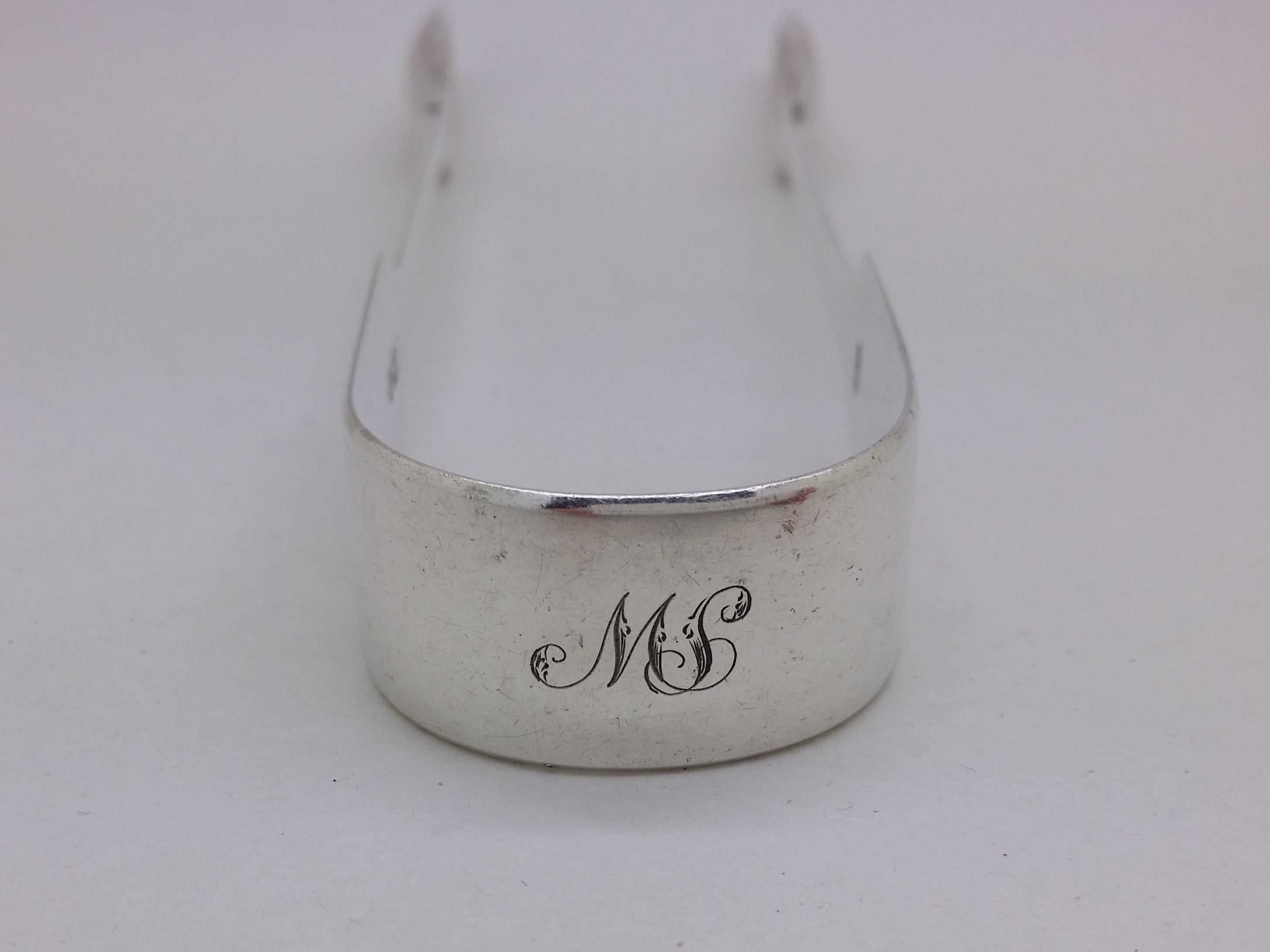 Bow of sterling silver sugar tongs with initial inscription MS