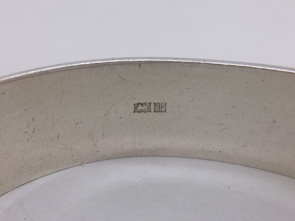 Hinged bangle supplementary hallmarks: lion passant mark for sterling silver; and Birmingham date letter W for 1971.