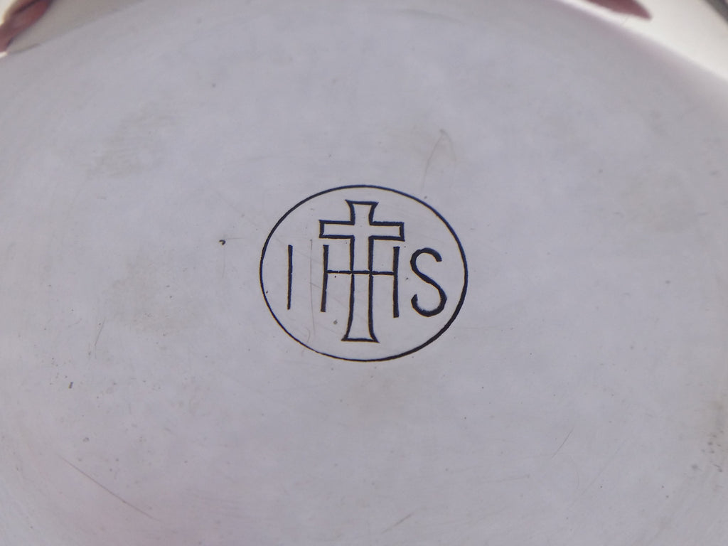 Circular cartouche with a cruciform, and the Christogram IHS, on sterling silver communion paten dish.