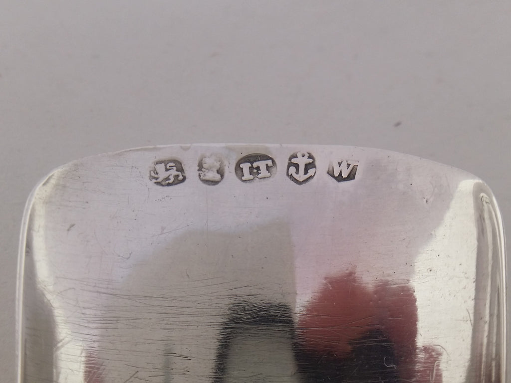 Caddy spoon hallmarks: lion passant mark for sterling silver; George III duty mark; Joseph Taylor maker's mark IT; anchor mark for Birmingham; Birmingham date letter w for 1820.