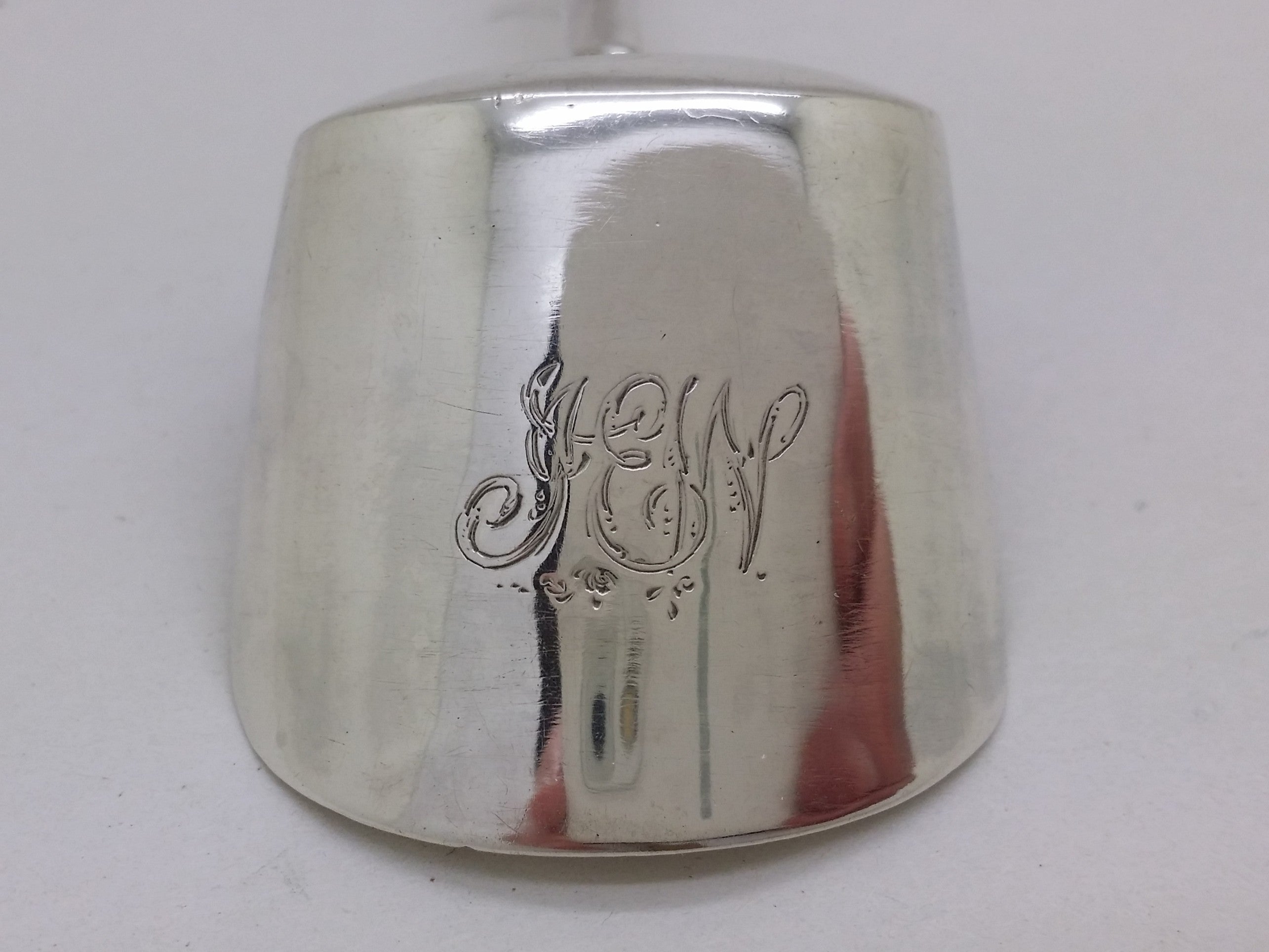 IEW initial inscription to the back of a sterling silver caddy spoon.